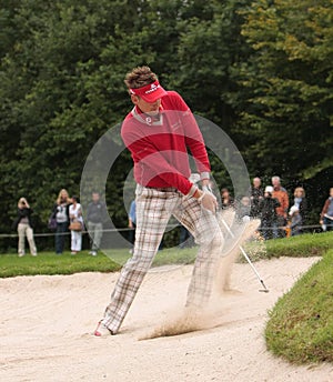 Ian Poulter plays bunkershot.