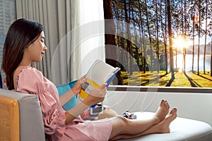 IAsian woman drink a coffee and tea in her hotel room