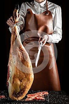 Iberian ham cutter. Traditional Spanish ham, Slicing of dry-cured. Hamon is forty-eight weeks old. gastronomic products of Spain