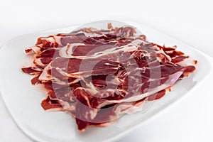 Iberian ham isolated in white background