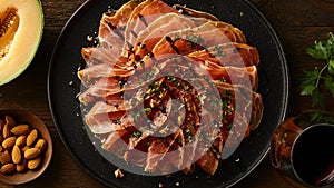 iberian ham and melon with balsamic drizzle photo