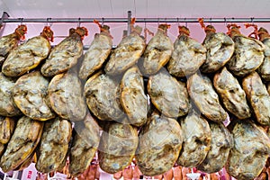 Iberian hams tasty prosciutto for sale in a market photo