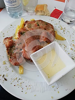 Iberian tenderloin steak with Torta del Casar sauce an fried potatoes . photo