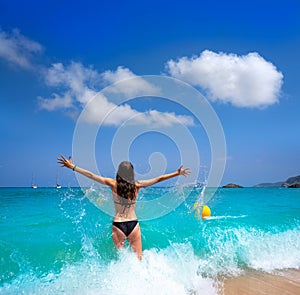 Ibiza beach girl splashing water in Balearics