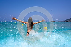 Ibiza beach girl splashing water in Balearics photo