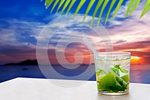 Ibiza cala Conta Conmte sunset with Mojito drink photo