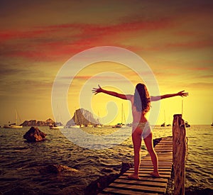 Ibiza cala d Hort girl pier sunset Es Vedra