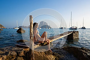 Ibiza cala d Hort girl pier sunset Es Vedra