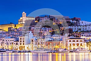 Ibiza Dalt Vila downtown at night with light reflections in the water, Ibiza, Spain.