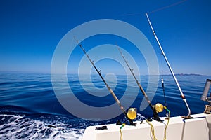 Ibiza fishing boat trolling rods and reels in blue sea