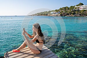 Ibiza girl taking smartphone photos