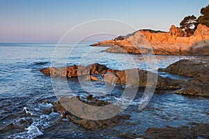 Ibiza seascape, Spain. Rocks in sea water in the morning photo