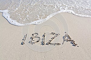 Ibiza written in sand