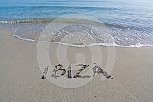 Ibiza written in sand