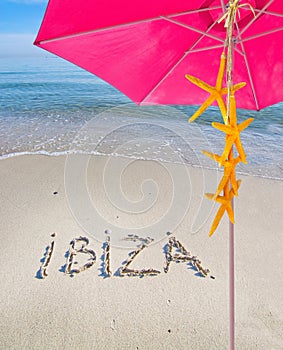 Ibiza written in sand