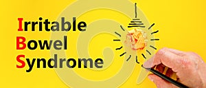 IBS irritable bowel syndrome symbol. Concept words IBS irritable bowel syndrome on a beautiful yellow background. Doctor hand.