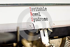 IBS irritable bowel syndrome symbol. Concept words IBS irritable bowel syndrome typed on old retro typewriter. White background.
