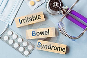 IBS - Irritable Bowel Syndrome, words on wooden blocks. Medical concept