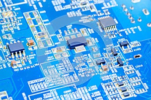 IC and electronic component on blue printed circuit board photo