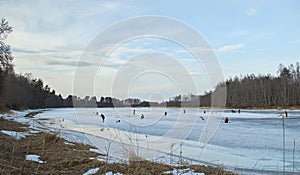 Ice anglers are fishing on the Venta River, Latvia