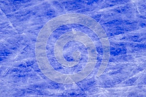Ice background with marks from skating and hockey, blue texture