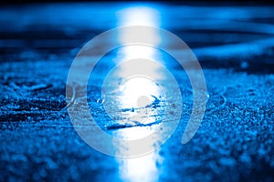 Ice background and texture with scratches from skating and hockey. Ice rink floor, detail of textured ice background