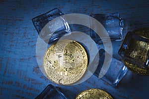 Ice and bitcoin coin. Freezing of cryptocurrency accounts. Frozen bitcoin coin.