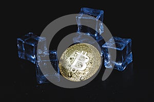 Ice and bitcoin coin. Freezing of cryptocurrency accounts. Frozen bitcoin coin.