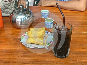 Ice black coffee and deep fried dough stick