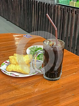 Ice black coffee and deep fried dough stick