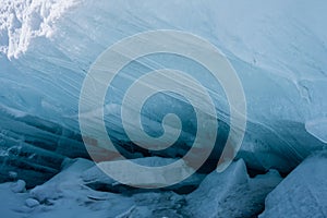 Ice blocks on the beach. Winter landscape with ice hummocks sparkling in the sun on the lake, the sea