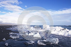 Ice blocks on a black sand beach