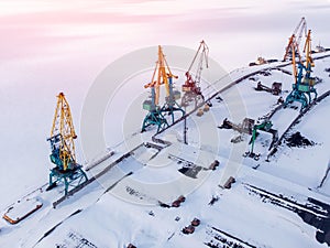 Ice bound frozen port for transshipment of coal from polar mines Container cargo ship loading North Arctic doc, top