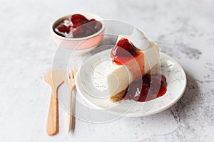 Ice box cheese cake with strawberry jam and whipping cream on white background