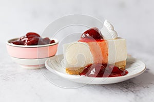 Ice box cheese cake with strawberry jam and whipping cream on white background