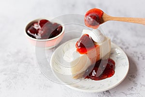 Ice box cheese cake with strawberry jam and whipping cream on white background