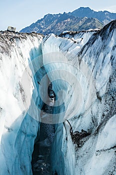 Ice bridge across a water filled crevasse on the Matanuska Glacier below Mount Wickersham