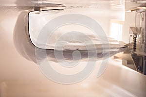 Ice buildup on the wall inside the freezer in a small refrigerator