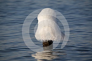 Ice capped pylon in water