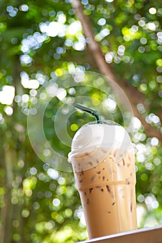 Ice cappuccino in plastice cup. Take away package. Beverage with