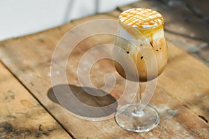 Ice caramel macchiato on wooden table