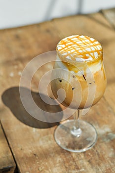 Ice caramel macchiato on wooden table