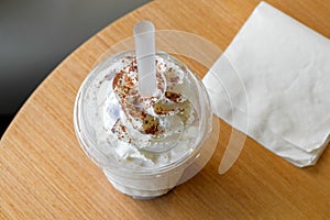 Ice chocolate frappe and whipped cream in the takeaway plastic cup