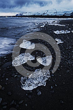 Ice chunks on the black sand `Ice Beach`, Iceland