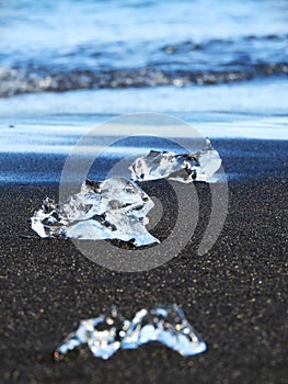 Ice Chunks Scattered on Black Sand at Diamond Beach in Iceland