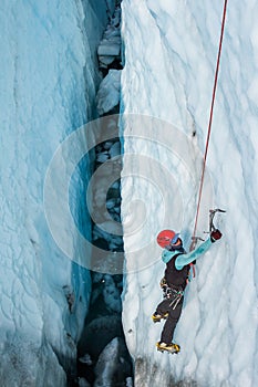 Ice climber deep inside a crevasse on the Matanuska Glacier, Alaska