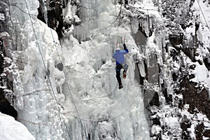 Ice climber on the frozen Boyana Waterfall in Vitosha Mountain near Sofia City, Bulgaria