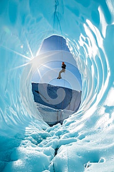 Ice climber rappels into ice cave on the Matanuska Glacier in the Alaskan Wilderness