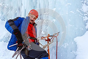 Ice climber with a serious face on the wall of a glacier