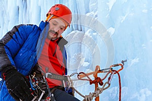 Ice climber with a serious face on the wall of a glacier